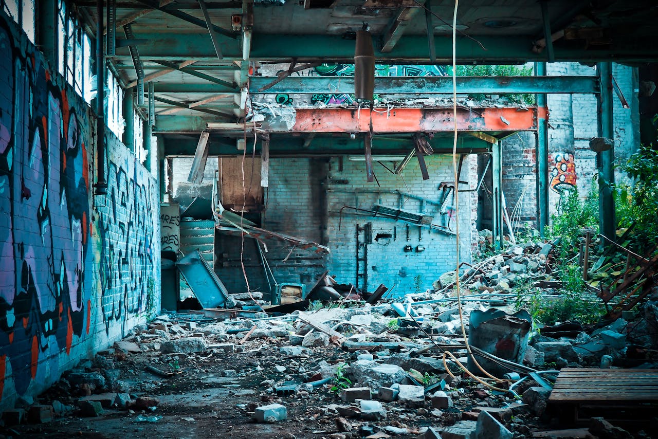 An urban exploration scene featuring graffiti and ruins in a dilapidated warehouse.